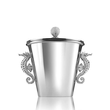 A polished sterling silver ice bucket with intricately sculpted seahorse handles and a lid, reflecting a marine theme.